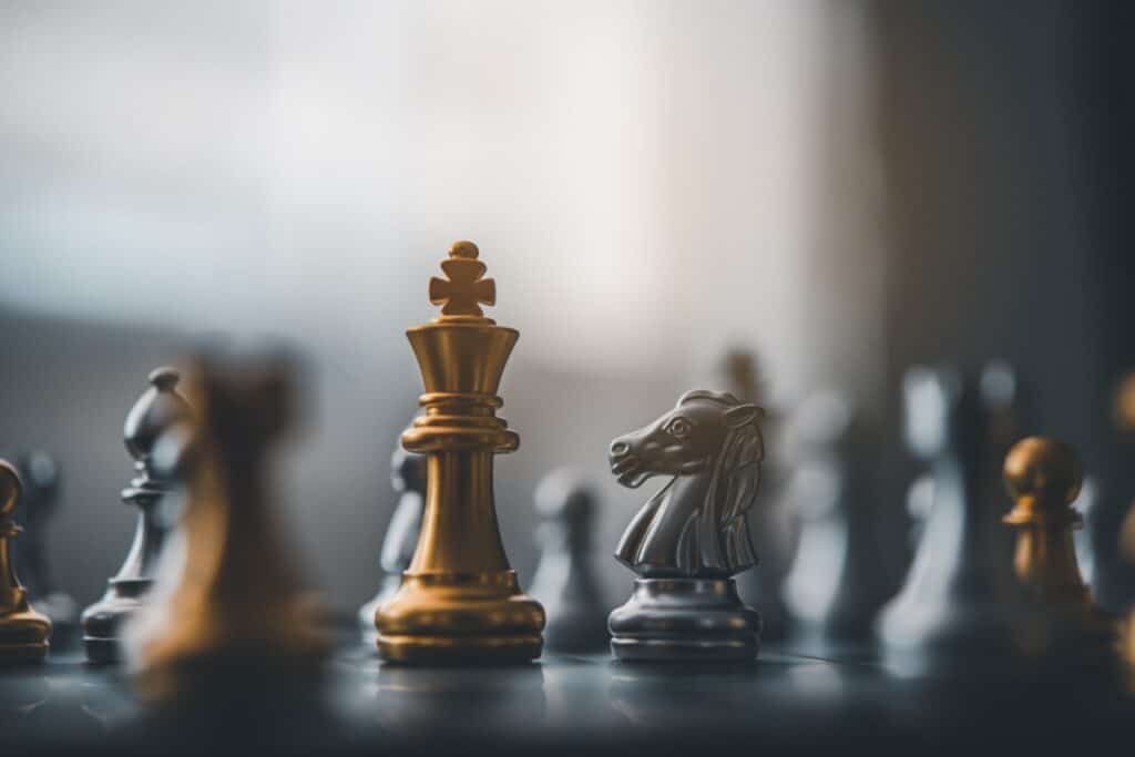 Close up of chess pieces on a game board, representing business strategy